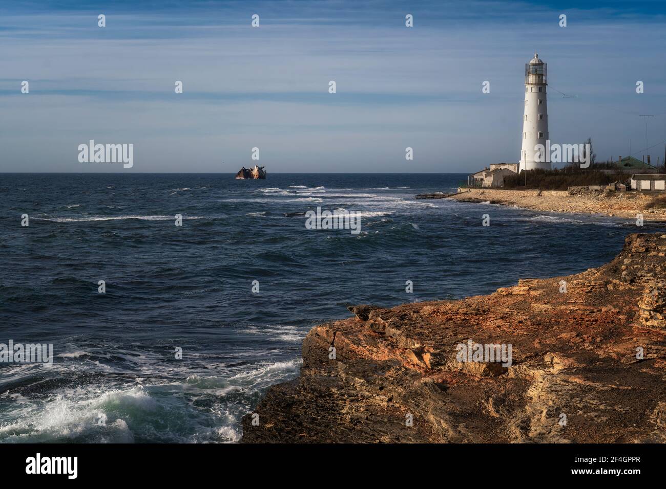 Lone beacon guards the ships. The lighthouse shows the way for boats ...