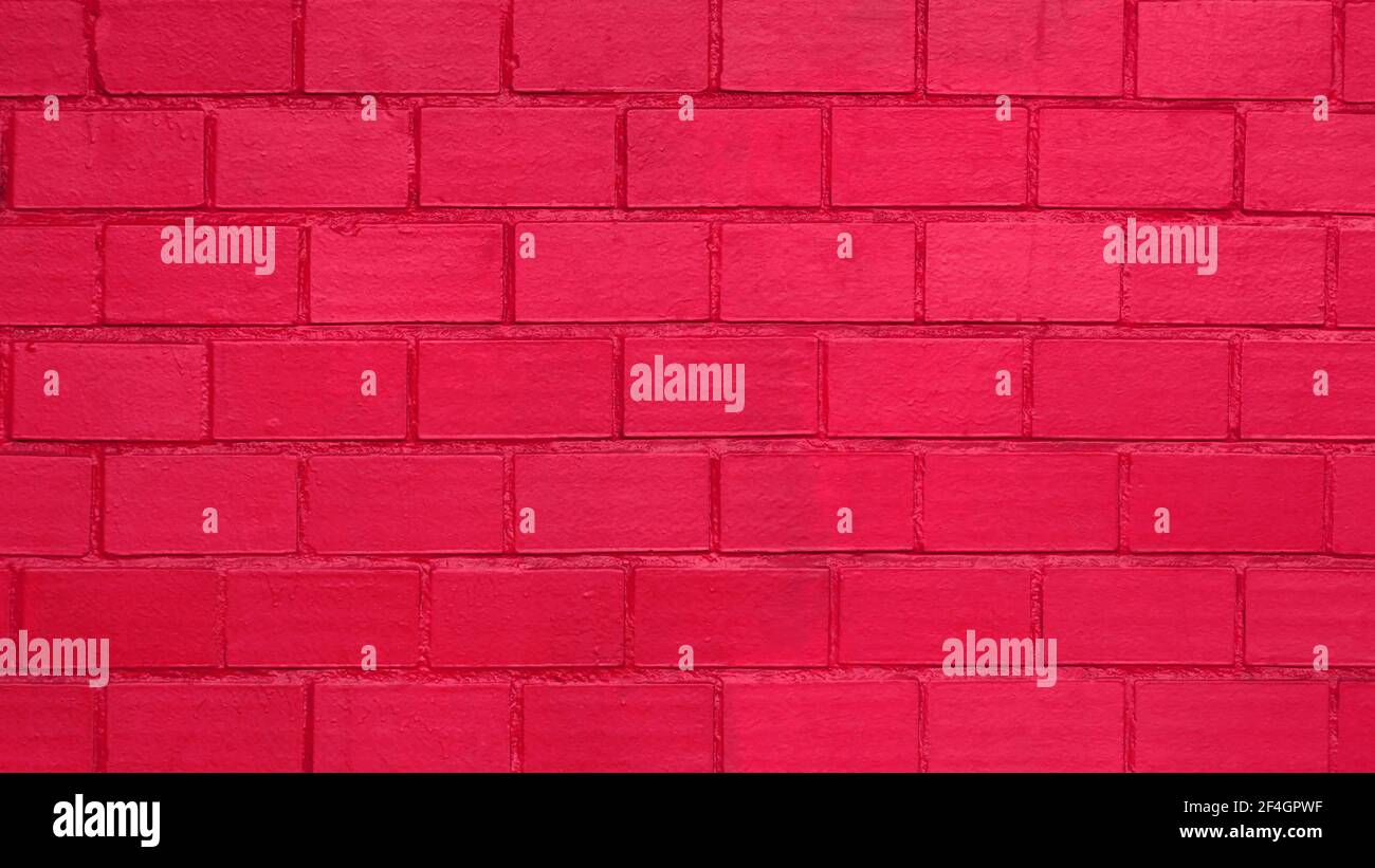 Painted brick wall as a background, saturated crimson red color Stock Photo