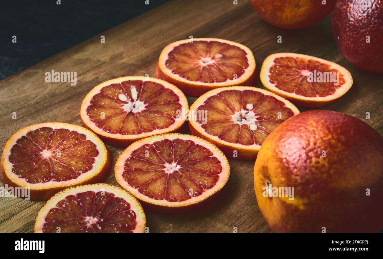 Red jucy oranges round sliced, close-up, shallow depth of field, stylized Stock Photo