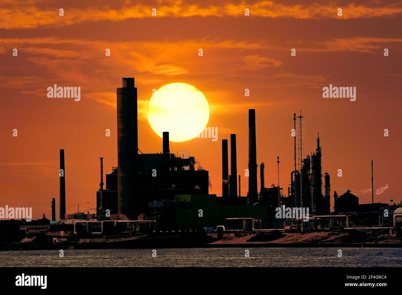 Sunsets over industrial complex on the Mississippi River near St Louis Missouri Stock Photo