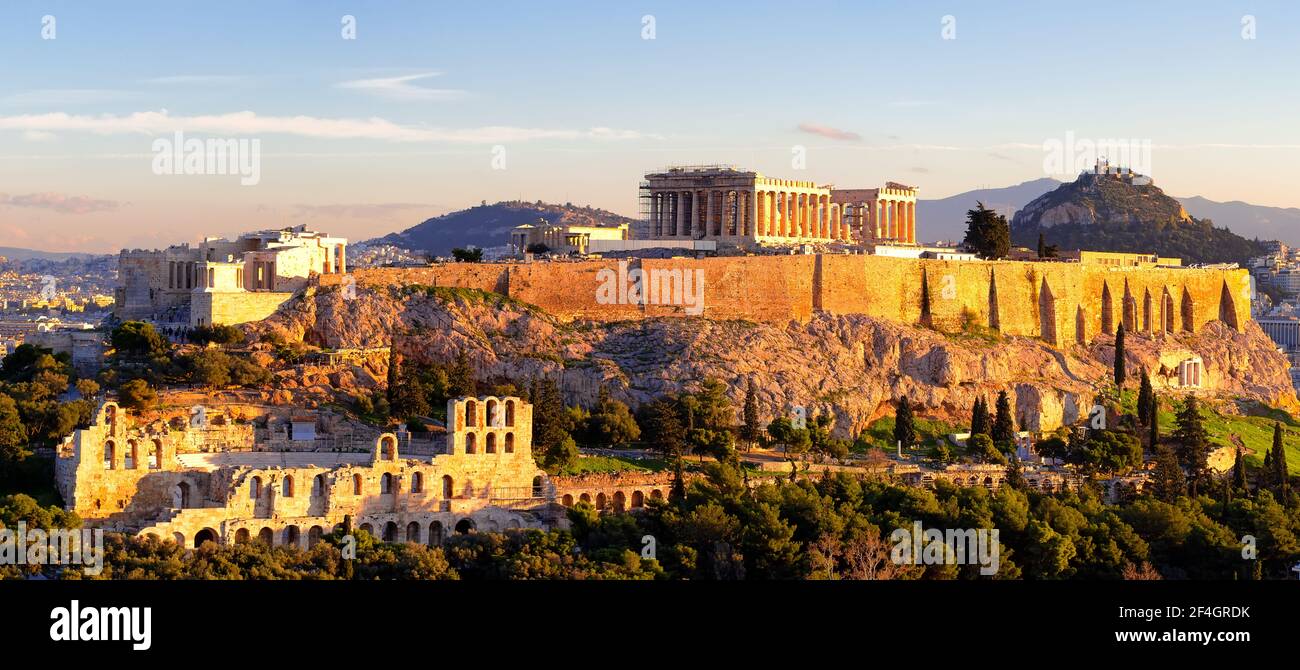 Panorama of Athens with Acropolis hill at sunset, Greece. The Acropolis of Athens located on a rocky outcrop above the city of Athens and contains the Stock Photo