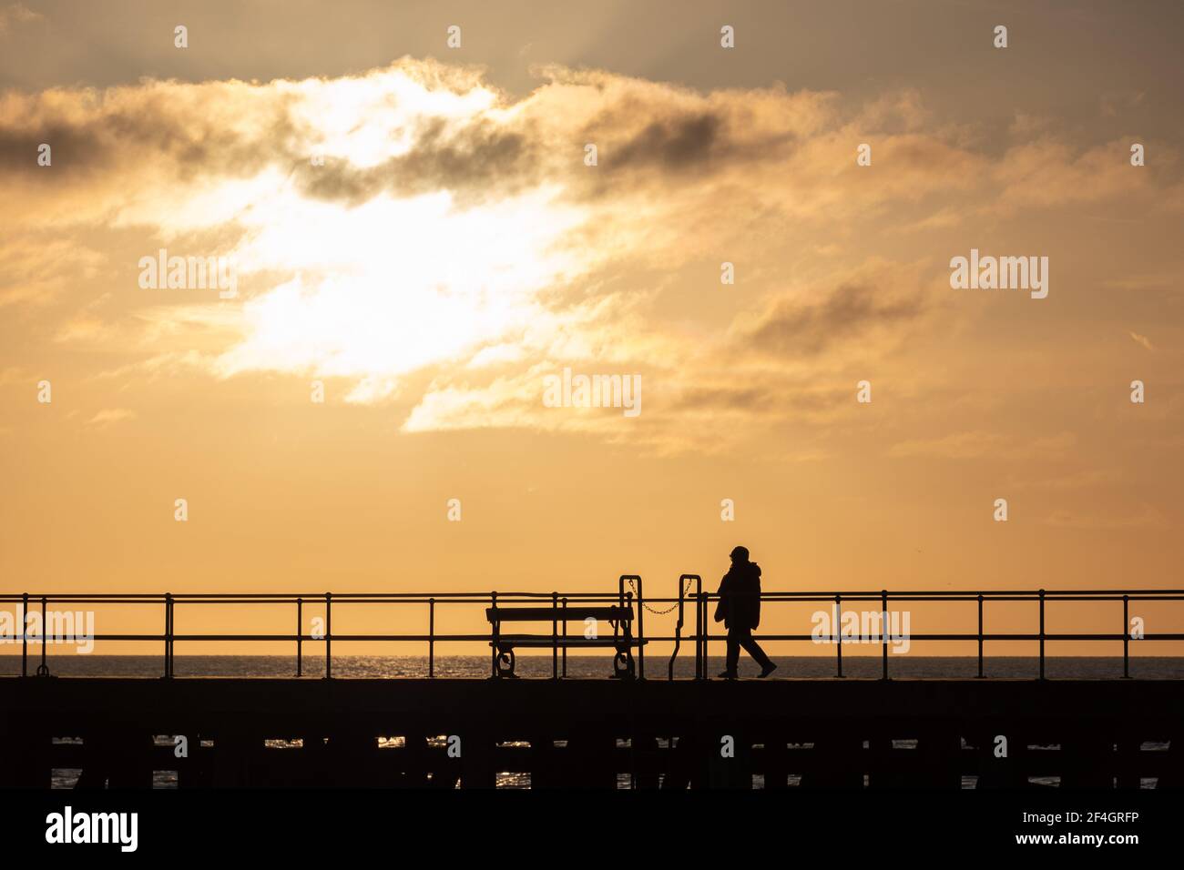 People enjoying the last of the sunshine on the first weekend of the year in Aberystwyth, Wales. Stock Photo