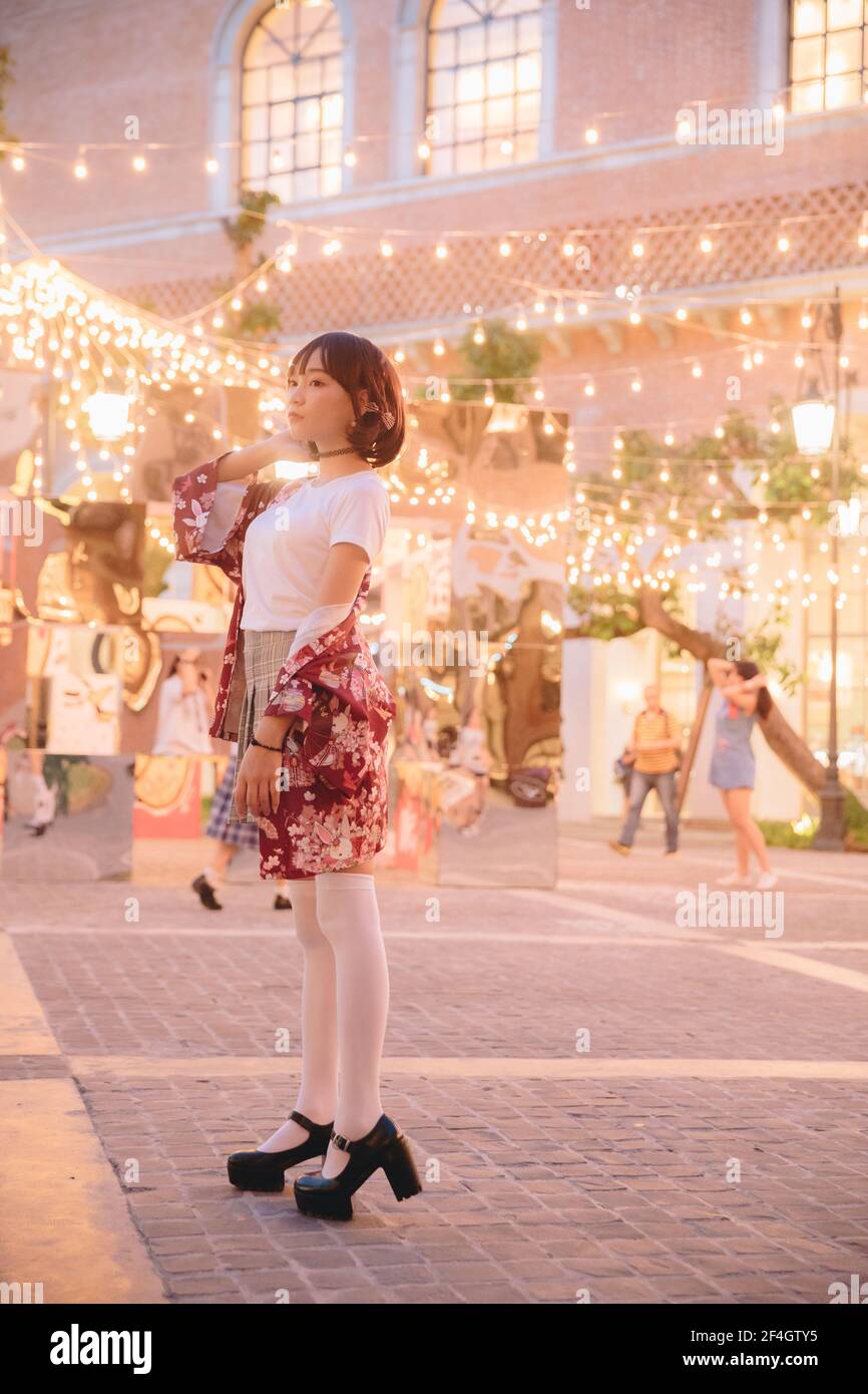 Portrait young woman thinking and looking modern style in outdoor urban ...