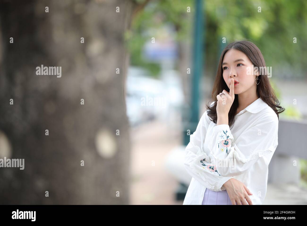 Portrait young woman thinking and looking modern style in outdoor urban ...