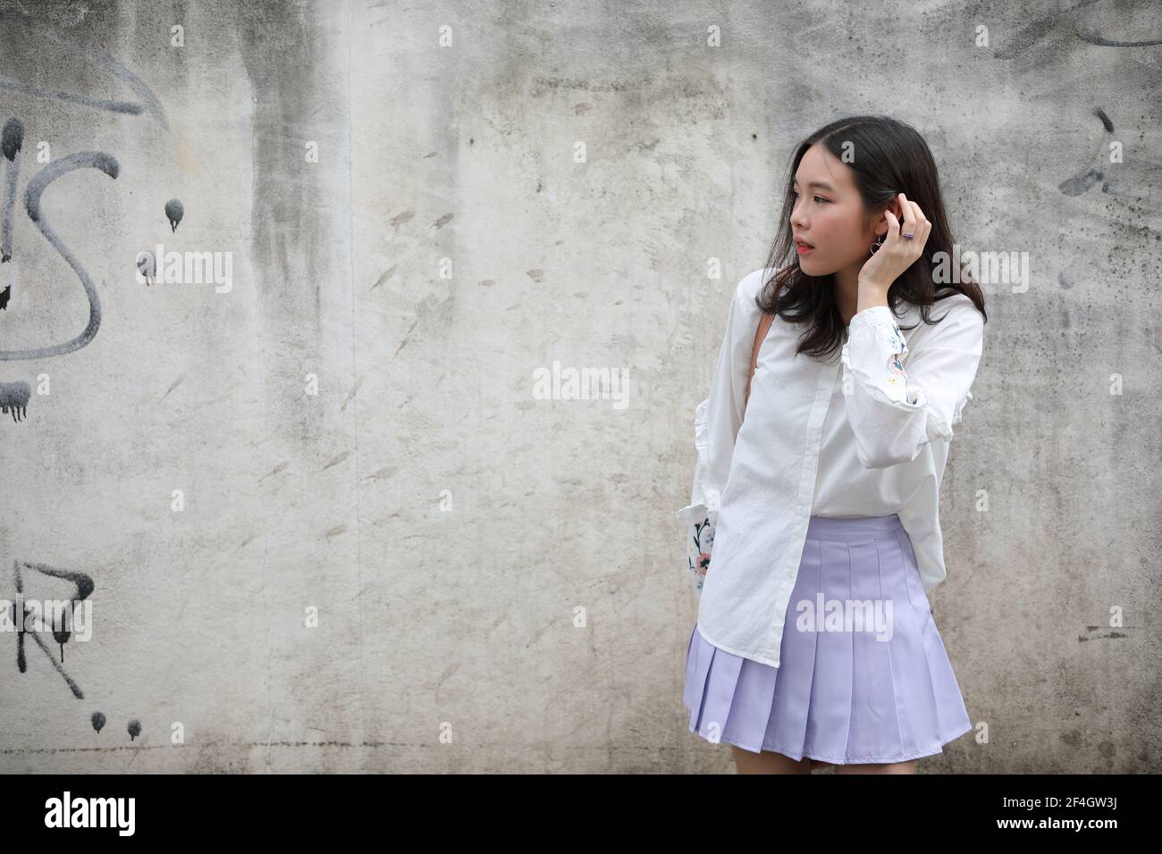 Portrait young woman thinking and looking modern style in outdoor urban ...