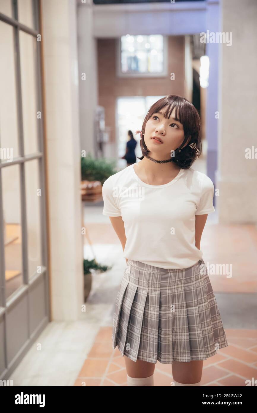 Portrait young woman thinking and looking modern style in outdoor urban ...