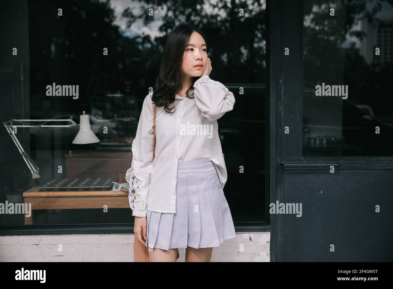 Portrait young woman thinking and looking modern style in outdoor urban ...