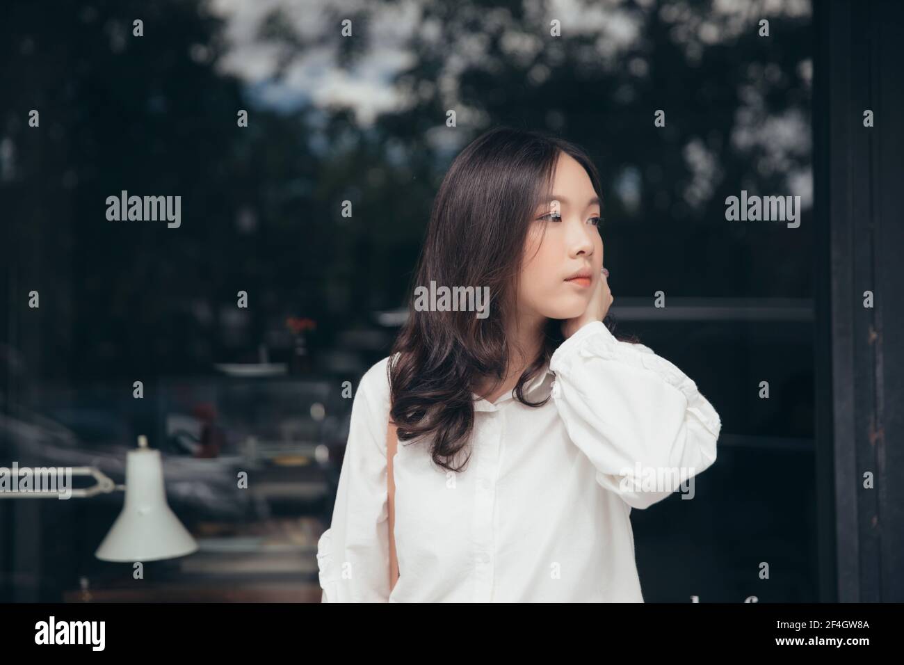 Portrait young woman thinking and looking modern style in outdoor urban ...