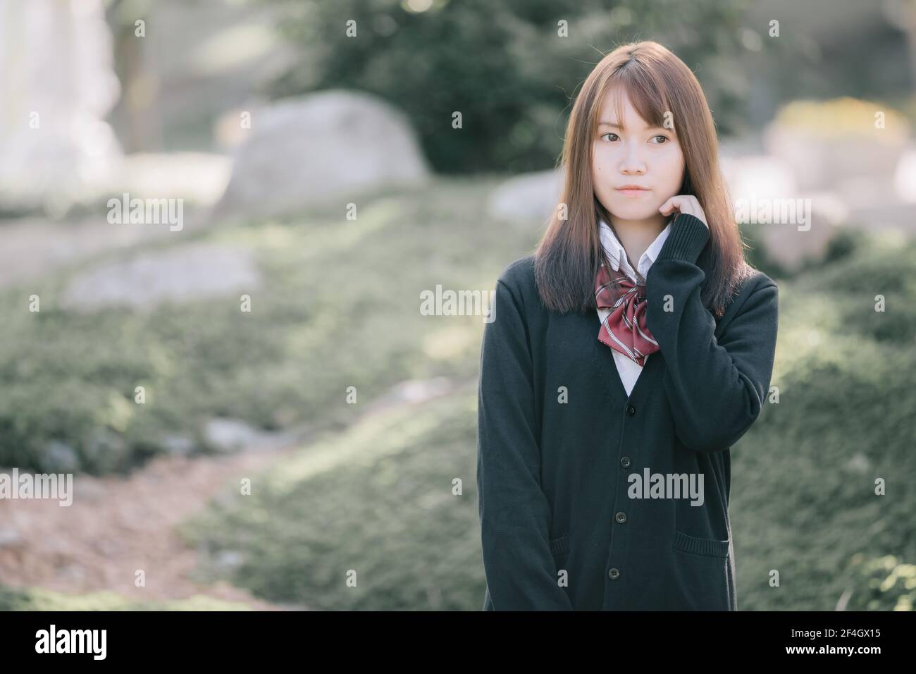 Portrait of asian japanese school girl costume looking at park outdoor