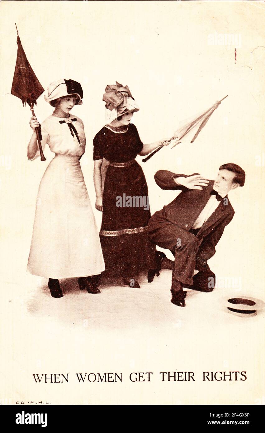 Anti-suffrage postcard, with a photograph depicting two young women menacing a man with their parasols, captioned 'When women get their rights, ' copyright by MHL, 1905. Photography by Emilia van Beugen. () Stock Photo
