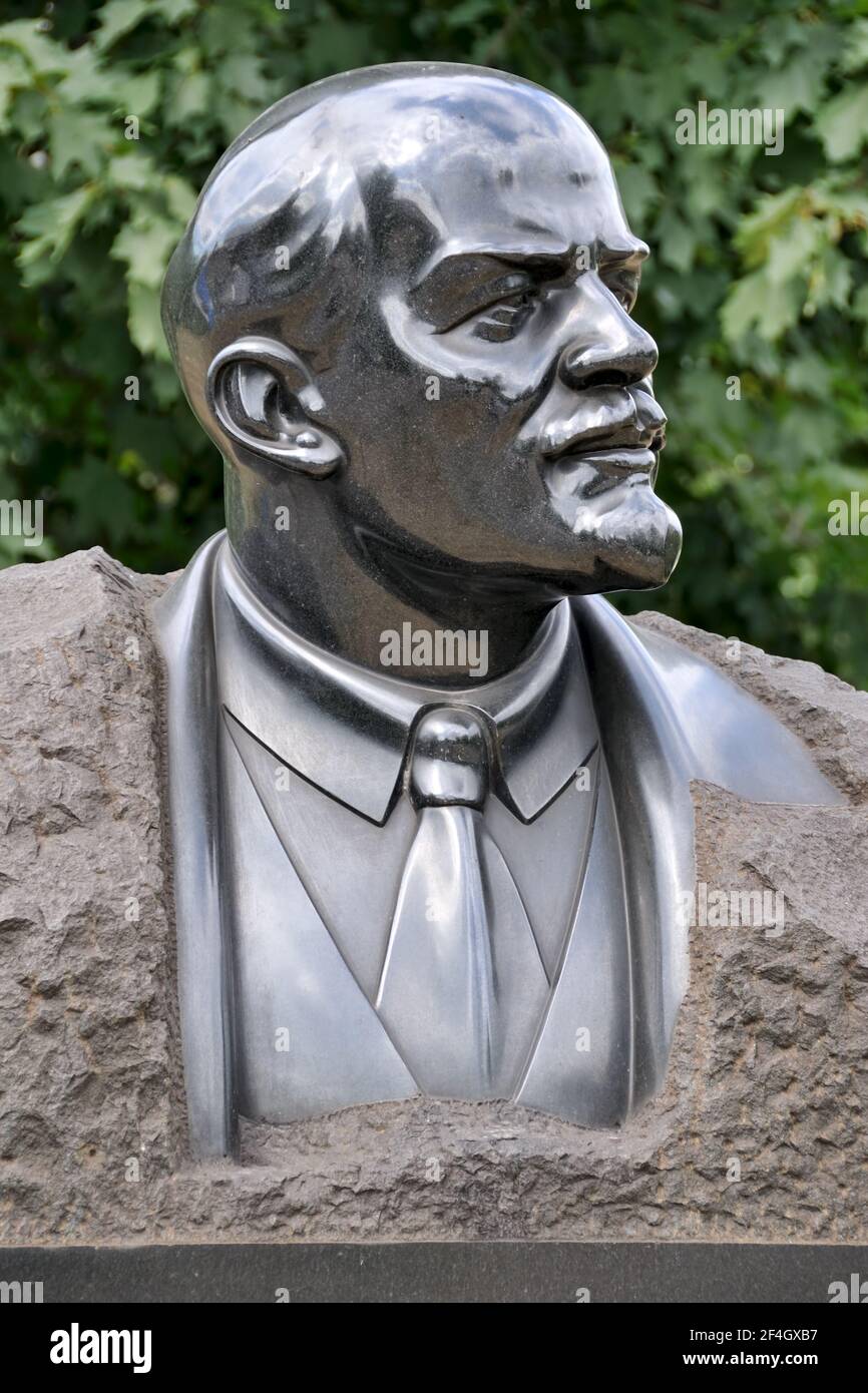 = Shining Granite Bust of Vladimir Lenin =  Shining like steel granite bust of Vladimir Ilyich Lenin (Ulyanov) in the park of art 'Muzeon' by sculptor Stock Photo
