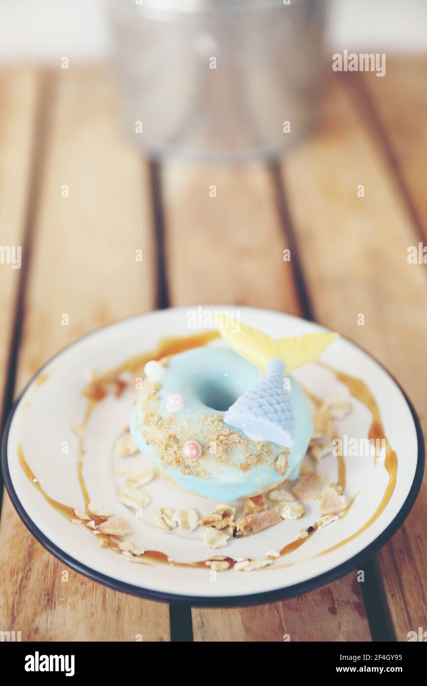 Fancy donut with cute mermaid on top Stock Photo