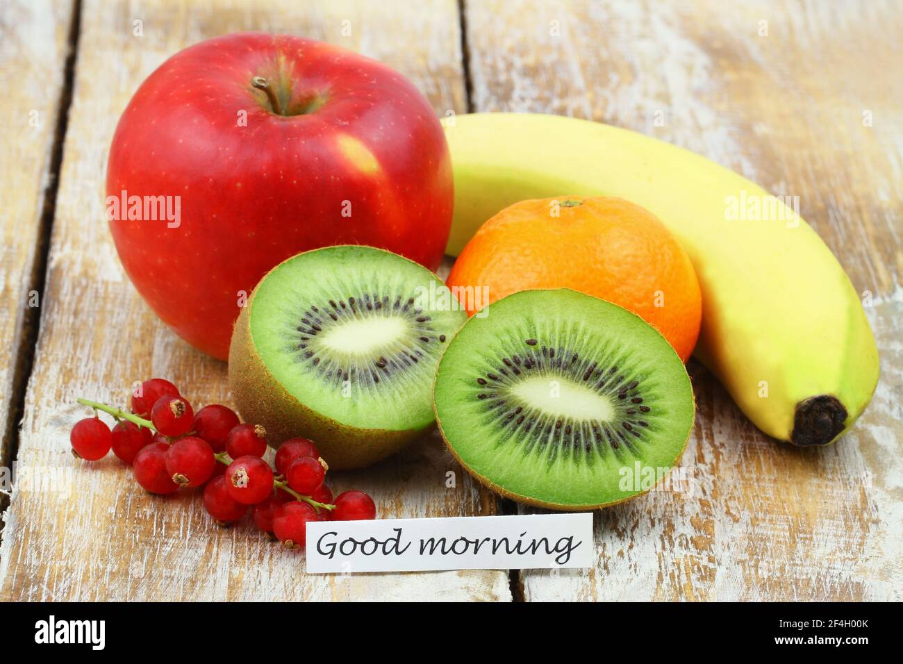 Good morning card with selection of healthy, fresh fruit on wooden surface Stock Photo