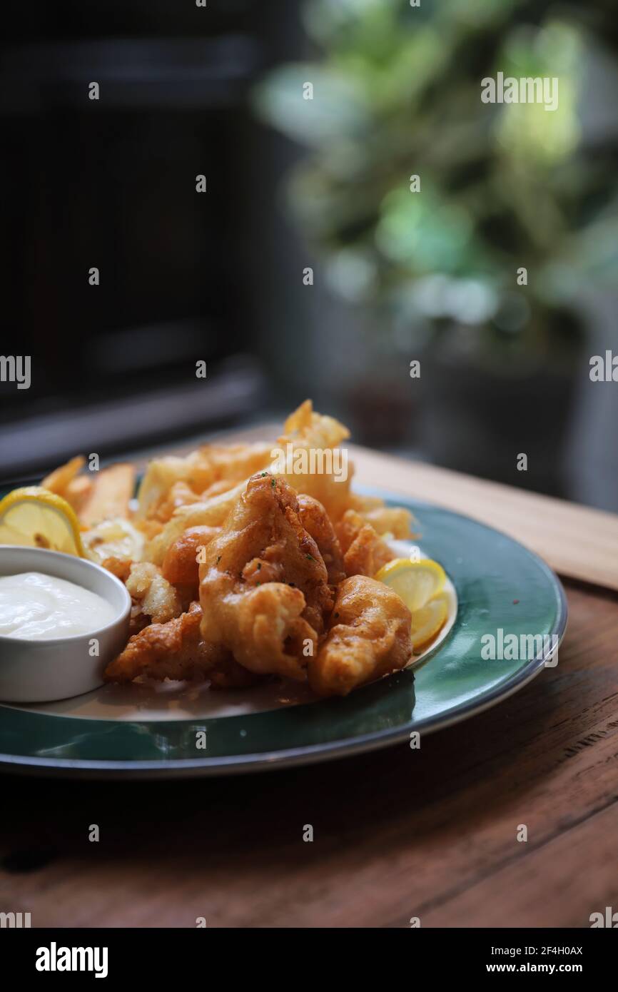 Fish and chips fried fish and potatoes on wood background vintage style Stock Photo