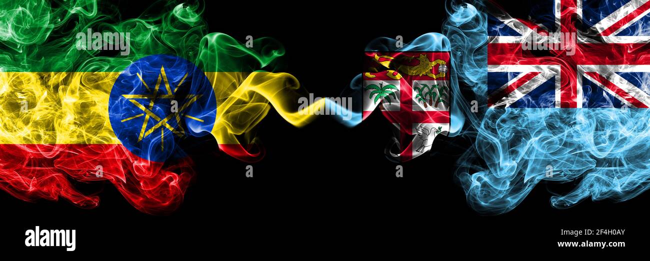 Ethiopia, Ethiopian vs Fiji, Fijian smoky mystic flags placed side by side. Thick colored silky abstract smoke flags. Stock Photo