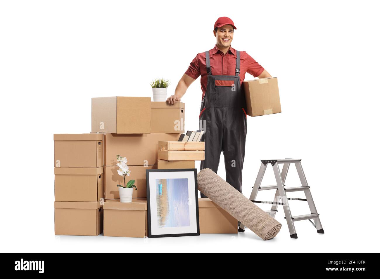 Professional mover posing with a pile of packed cardboard boxes ready for removal isolated on white background Stock Photo