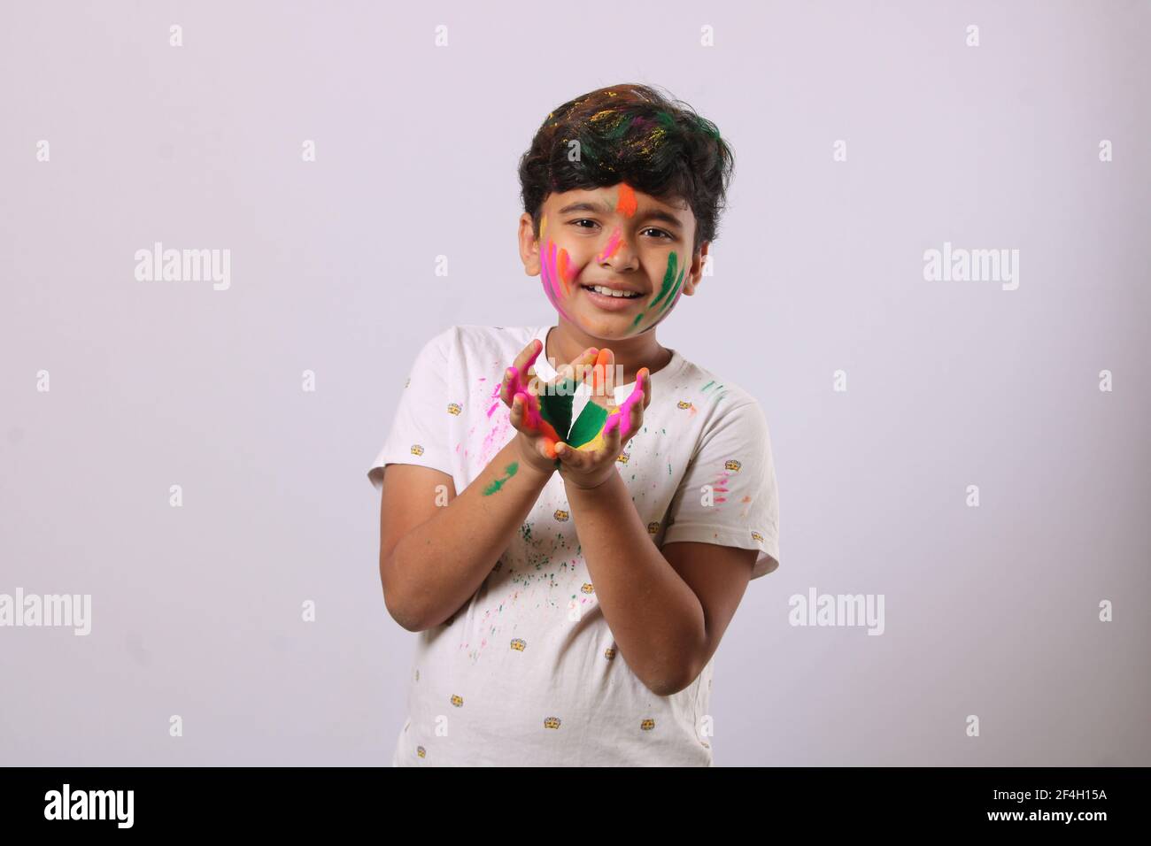 Concept for Indian festival. kid playing with colours or asian children celebrating holi - festival of colours Stock Photo