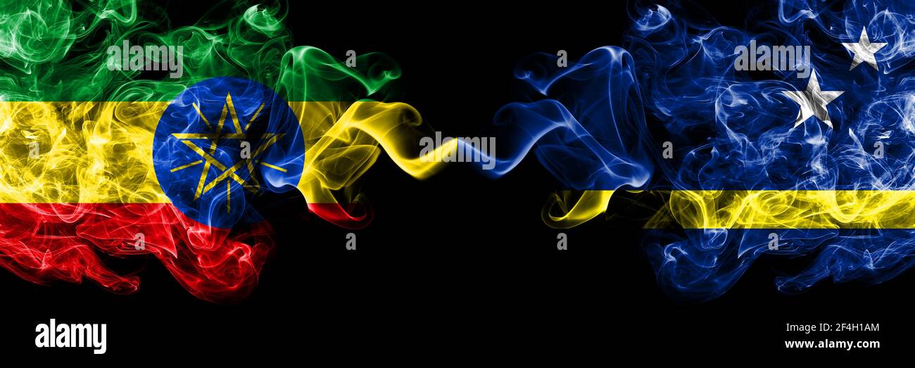 Ethiopia, Ethiopian vs Netherlands, Dutch, Holland, Curacao smoky mystic flags placed side by side. Thick colored silky abstract smoke flags. Stock Photo