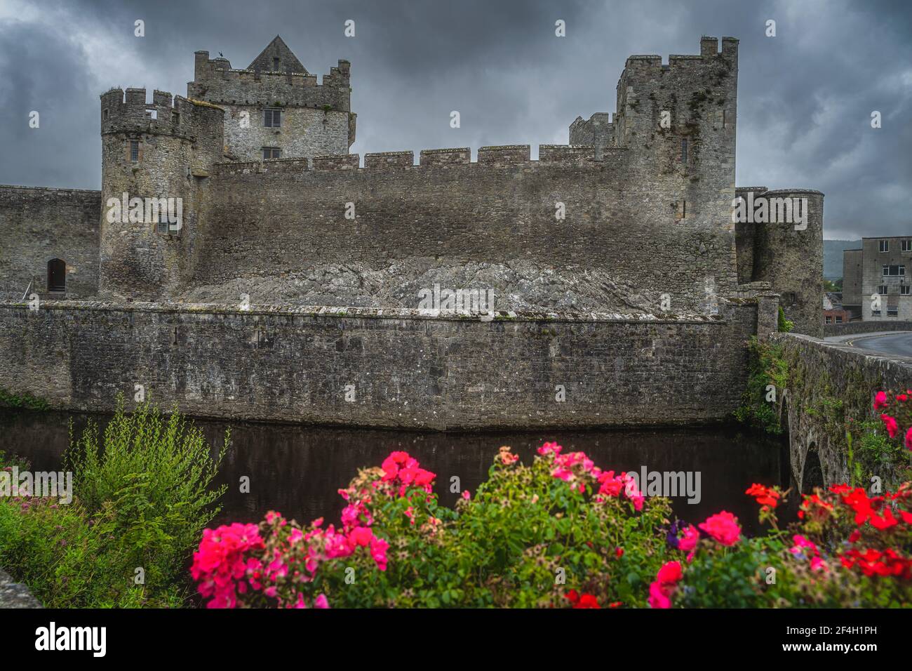 12th century Cahir castle with moat in Cahir town with dramatic, storm sky in background, County Tipperary, Ireland Stock Photo