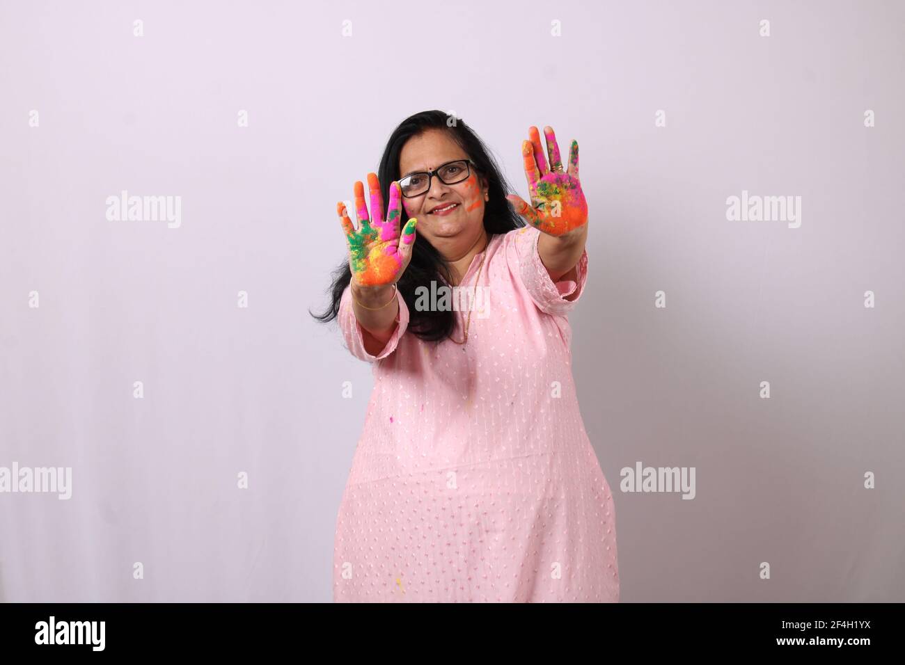 Holi. Portrait of happy indian woman celebrating Festival Of Colours. Stock Photo
