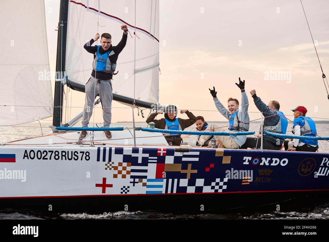 Russia, St.Petersburg, 05 September 2020: The team celebrates a victory in race, a sailing regatta on the sailboat, pull ropes, water splashes in the Stock Photo