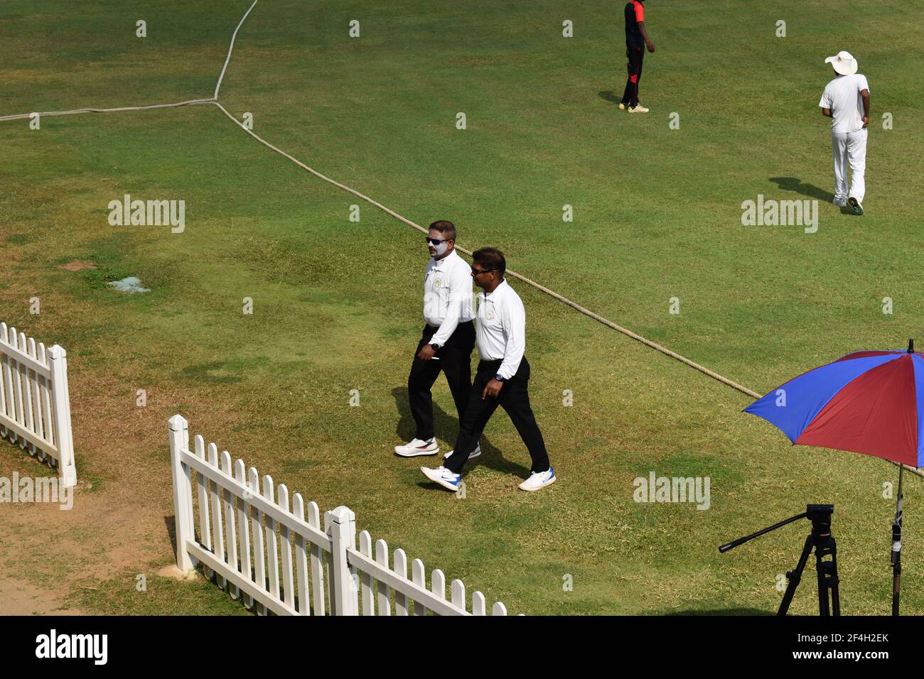 Umpires walking in during a cricket match. Picturistic school cricket ground. St. Thomas College, Mt. Lavinia. Colombo, Sri Lanka. Stock Photo