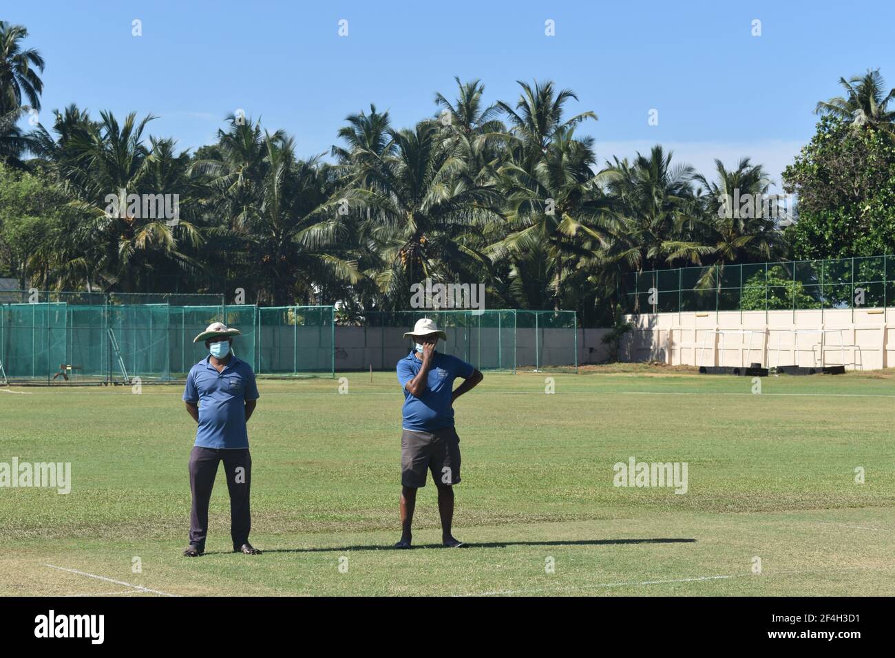 Ground staff preparing the turf wicket and ground for a cricket match at the picturistic school cricket ground. St. Thomas College, Mt. Lavinia. Colombo. Sri Lanka. Stock Photo