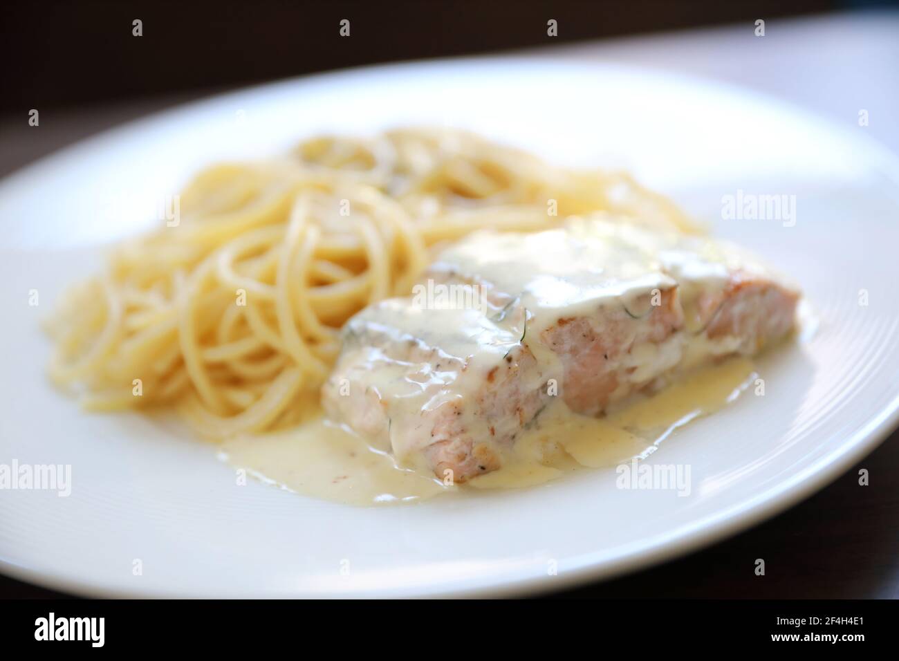 Grilled salmon with lemon cream sauce with pasta Stock Photo - Alamy
