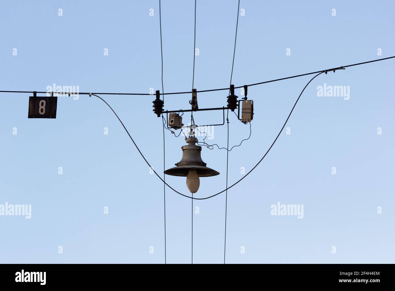 Cables and wires above the city street with old retro looking lamp with