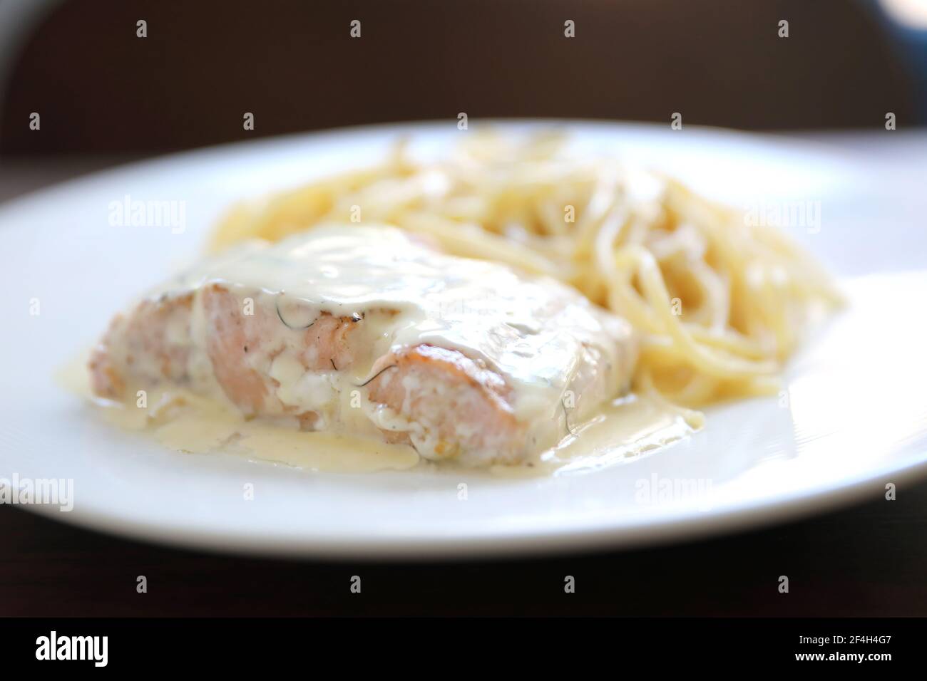 Grilled salmon with lemon cream sauce with pasta Stock Photo - Alamy