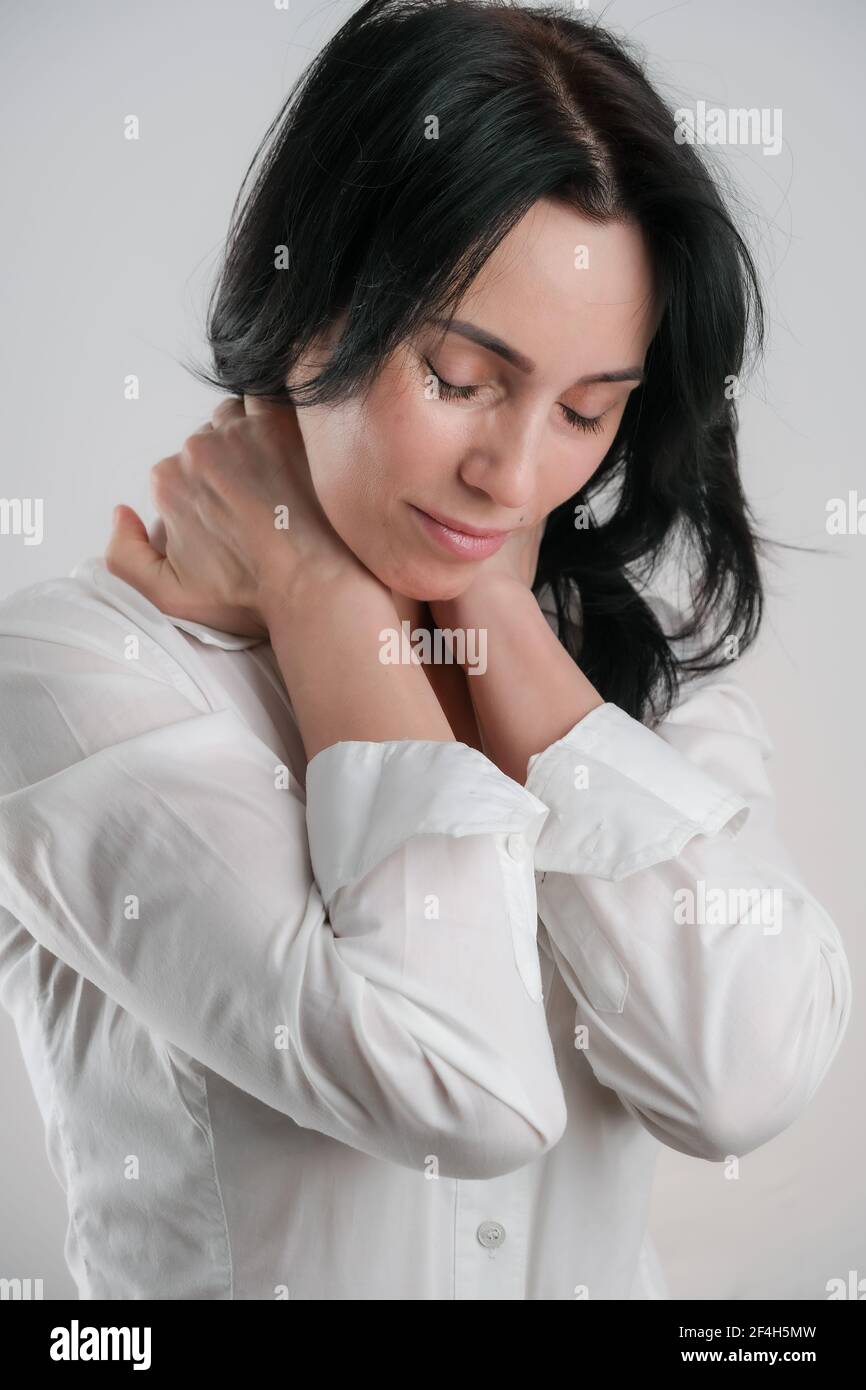 Portrait of beautiful mature brunette woman isolated on grey white background, copy space Stock Photo