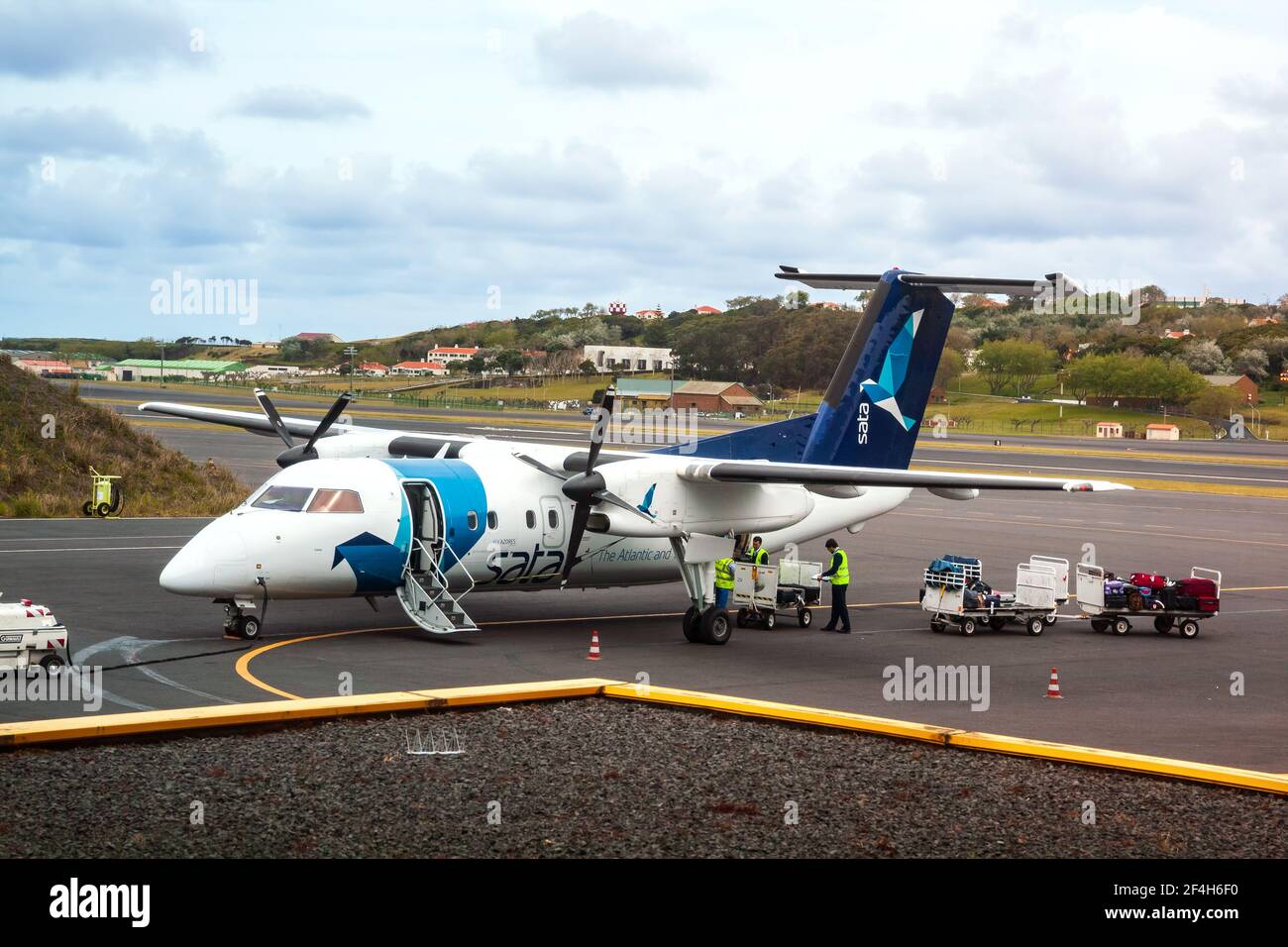 TERCEIRA, AZORES, PORTUGAL - MAY, 2012: Small turboprop aircraft Bombardier Q200 of airline SATA Air Açores flies between islands of Azores archipelag Stock Photo