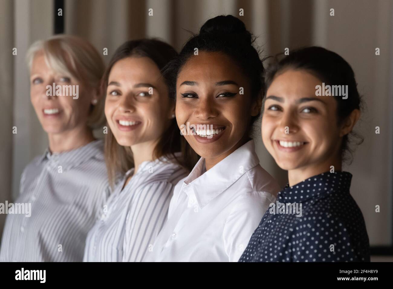 Portrait of smiling multiracial female colleagues posing Stock Photo