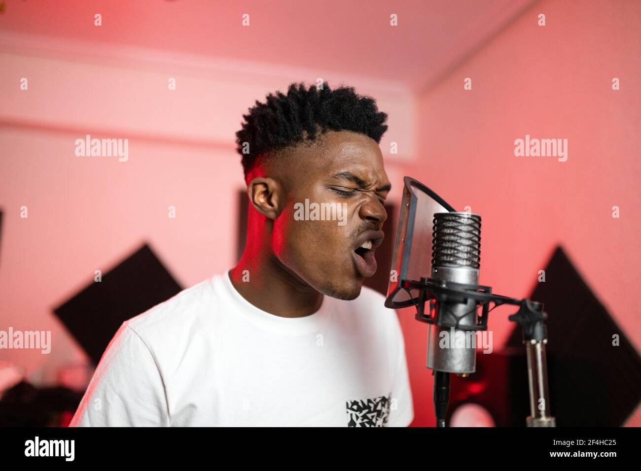 Young African American vocalist with open mouth and modern haircut