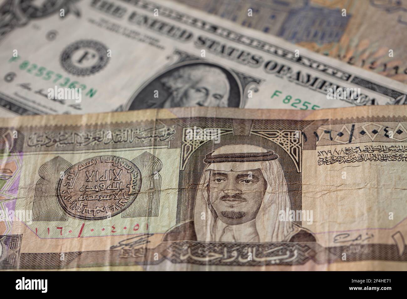 old one riyal of Saudi Arabia and 1 US dollar banknotes for design purpose Stock Photo