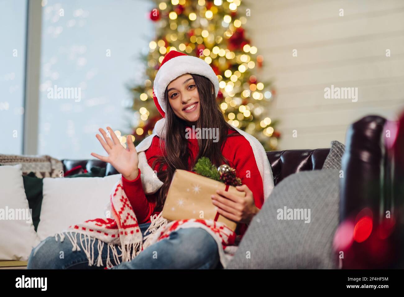 Girl holding a Christmas present on New Years Eve Stock Photo - Alamy