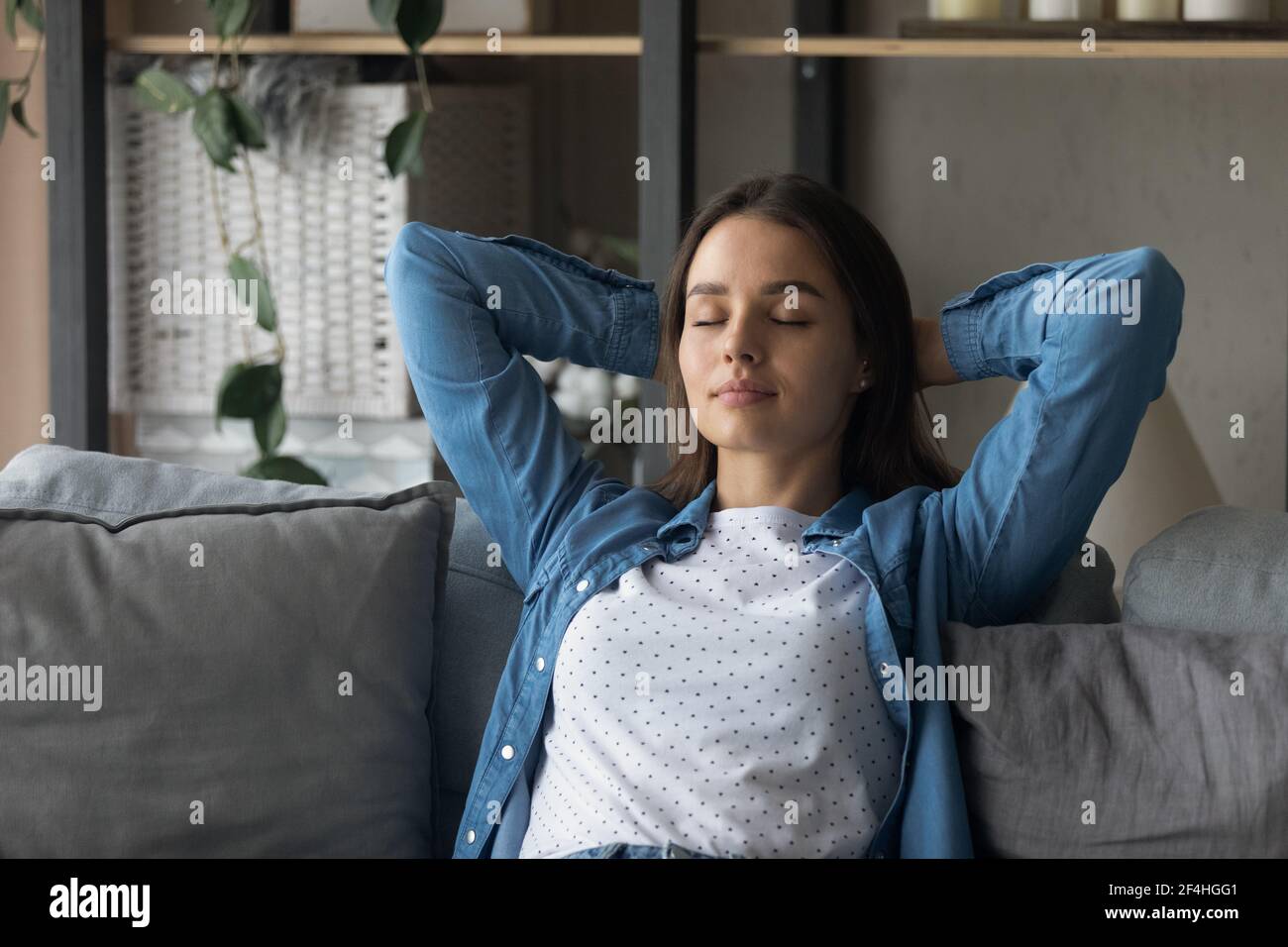 Close up peaceful woman with closed eyes relaxing on couch Stock Photo ...