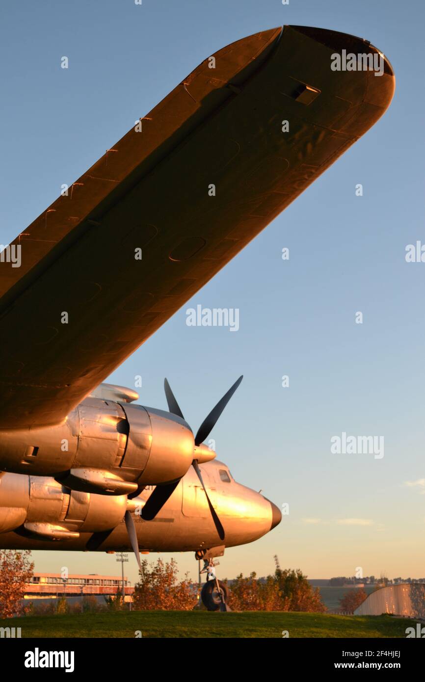 Douglas DC-7 Transport Aircraft on the Bank of the Guadalquivir River, Córdoba, Spain. Propellers, engines, the nose & tail fin, early evening sunset. Stock Photo