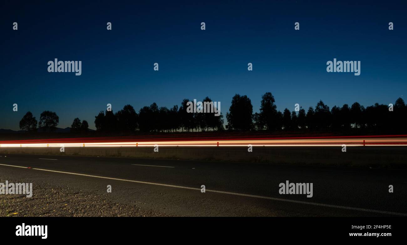Light trail and Tuggeranong parkway highway in Canberra from the side of the road Stock Photo