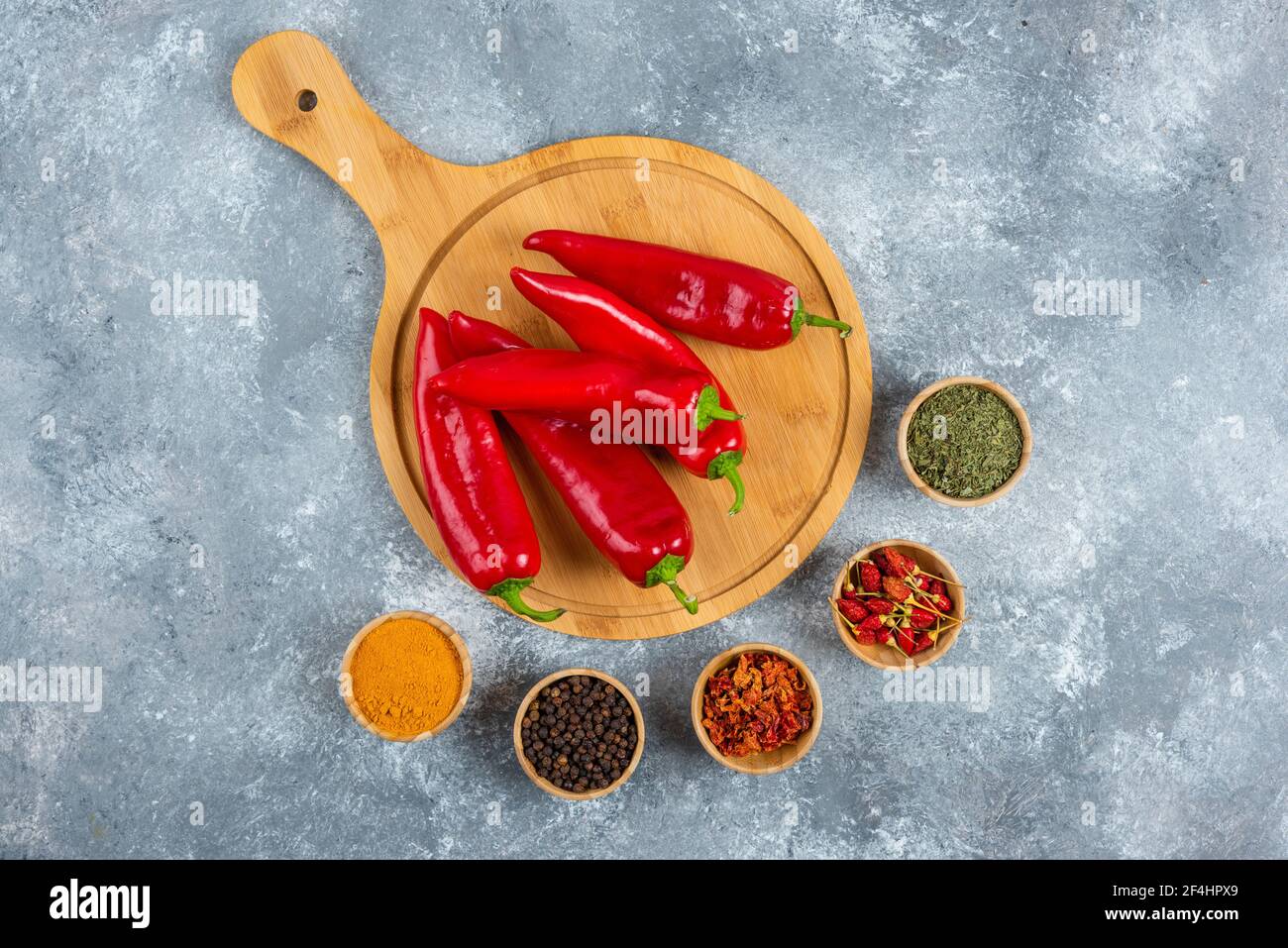 Red chili peppers on wooden board with spices Stock Photo - Alamy