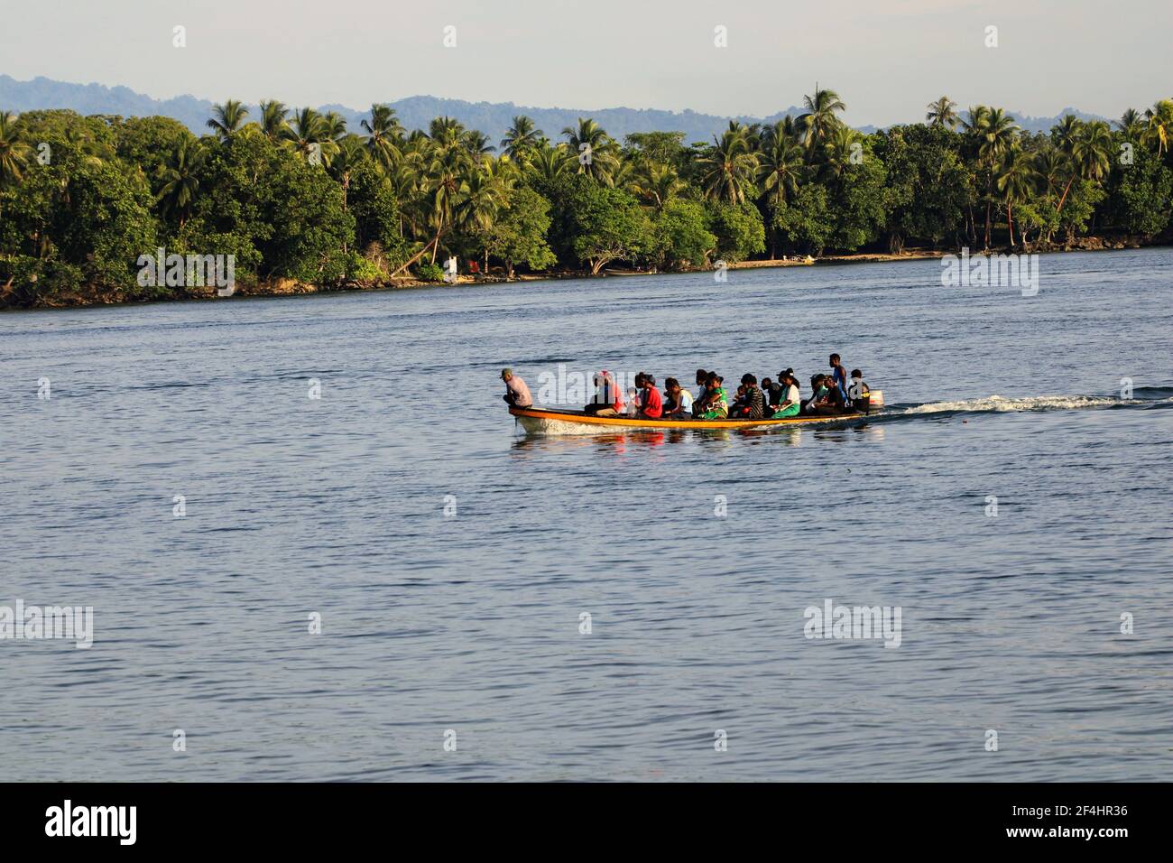 A boatload of passengers being ferried from Kranket Island to Madang town in a fiberglass dinghy. Stock Photo