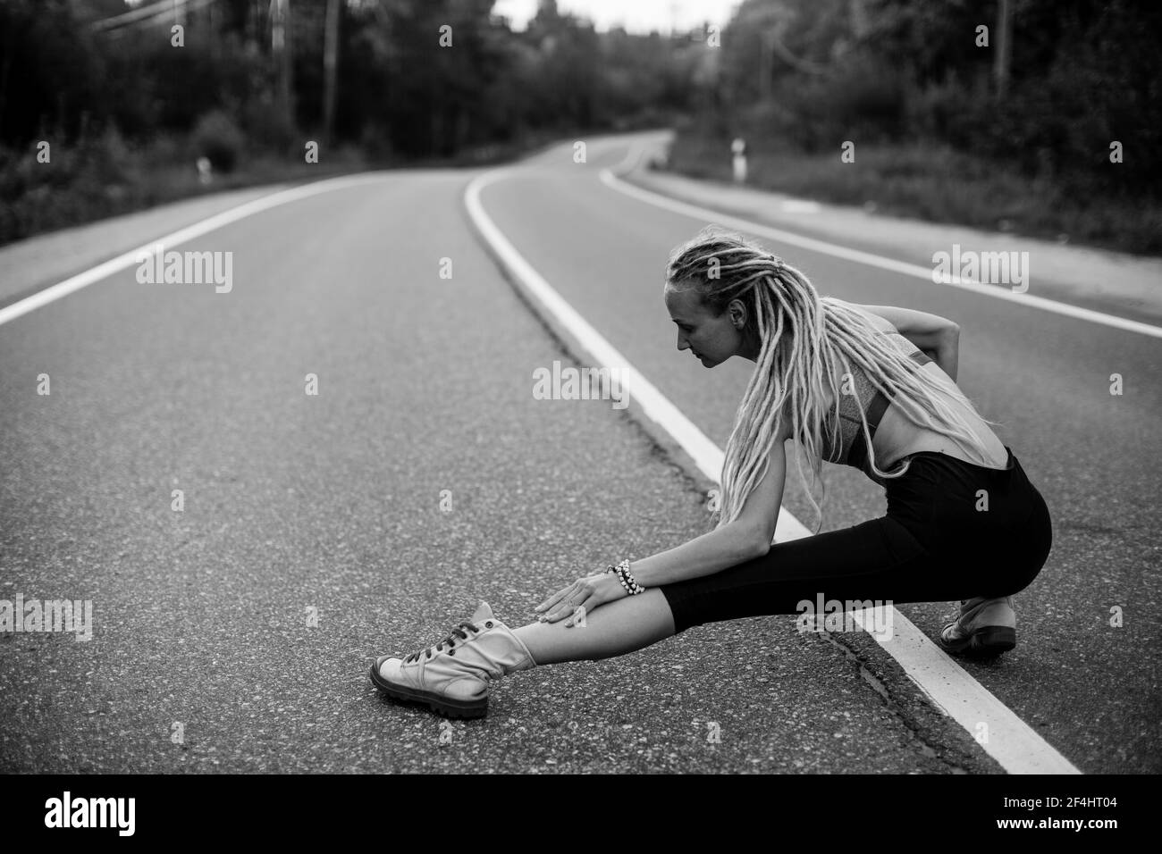 Runnung woman warm-up before jogging. Black and white photo. Stock Photo