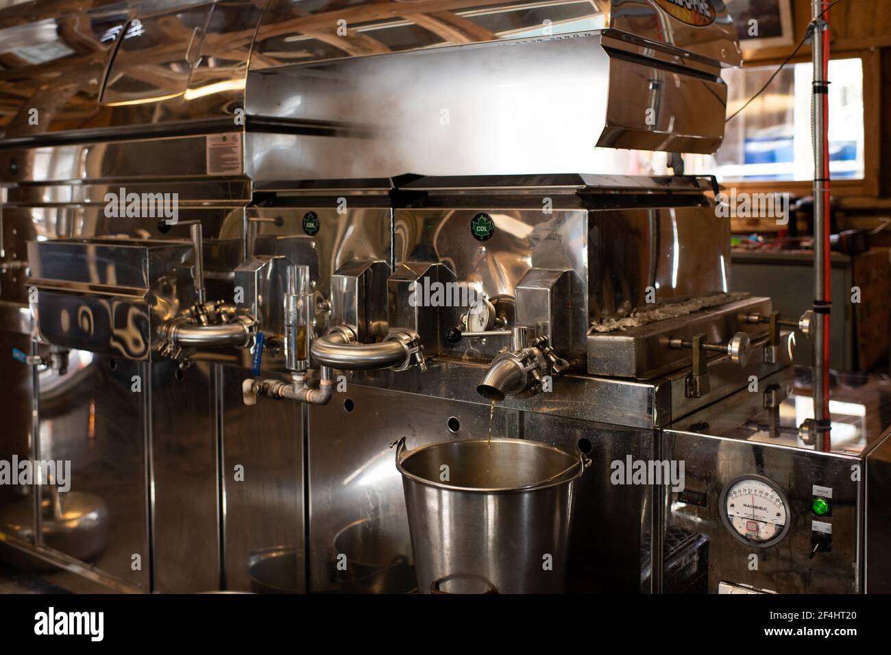 A maple syrup evaporator plant in operation at the McComb's Oak Hill Farm in Speculator, NY in the Adirondack Mountains with rising steam. Stock Photo