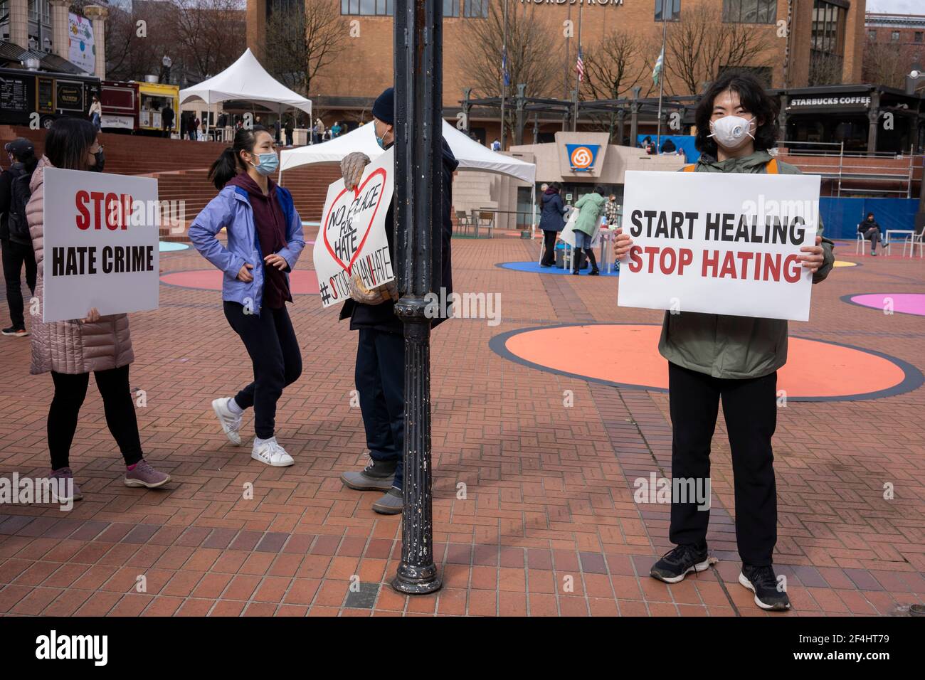 Peaceful demonstrators are seen in downtown Portland's Pioneer Courthouse Square denouncing violence against Asian Americans on Sunday, March 21, 2021. Stock Photo