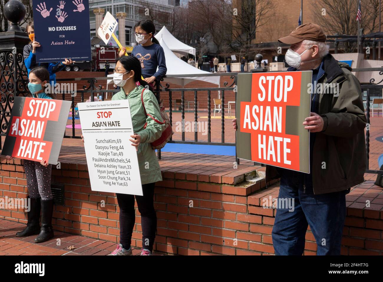 Peaceful demonstrators are seen in downtown Portland's Pioneer Courthouse Square denouncing violence against Asian Americans on Sunday, March 21, 2021. Stock Photo