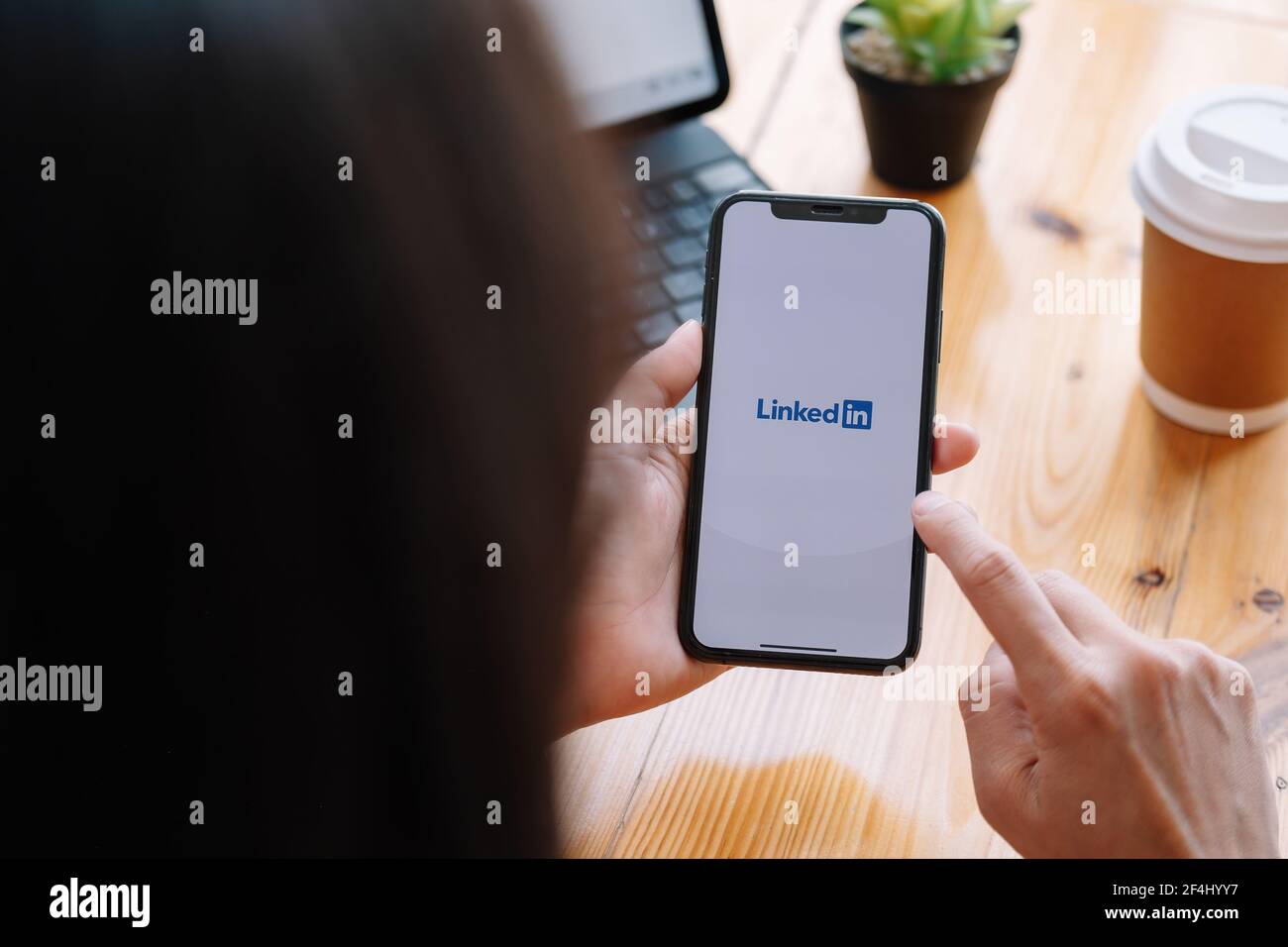 CHIANG MAI, THAILAND, MAR 21, 2021 : A women holds Apple iPhone Xs with LinkedIn application on the screen.LinkedIn is a photo-sharing app for Stock Photo