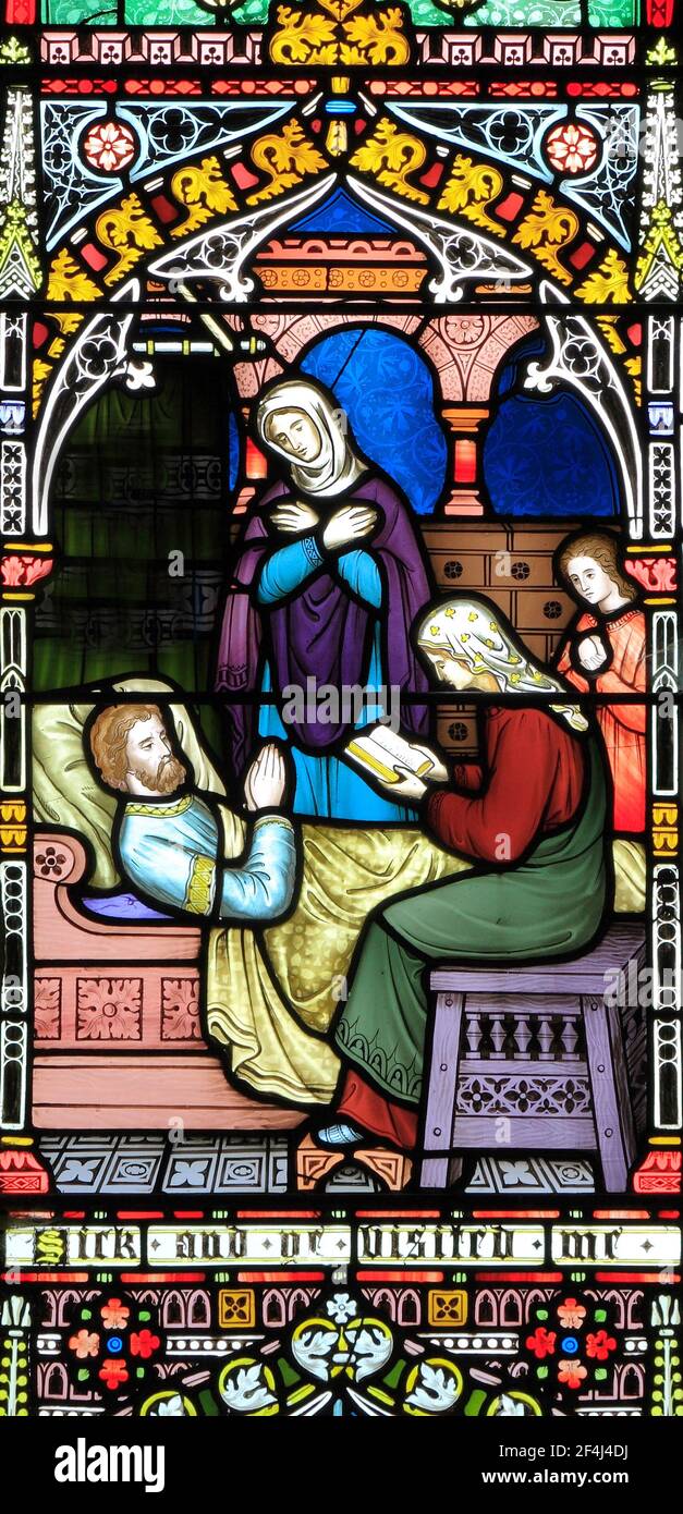 Corporal Acts of Mercy window, stained glass window by Frederick Preedy, 1868, visiting the sick, Gunthorpe, Norfolk, England, UK Stock Photo