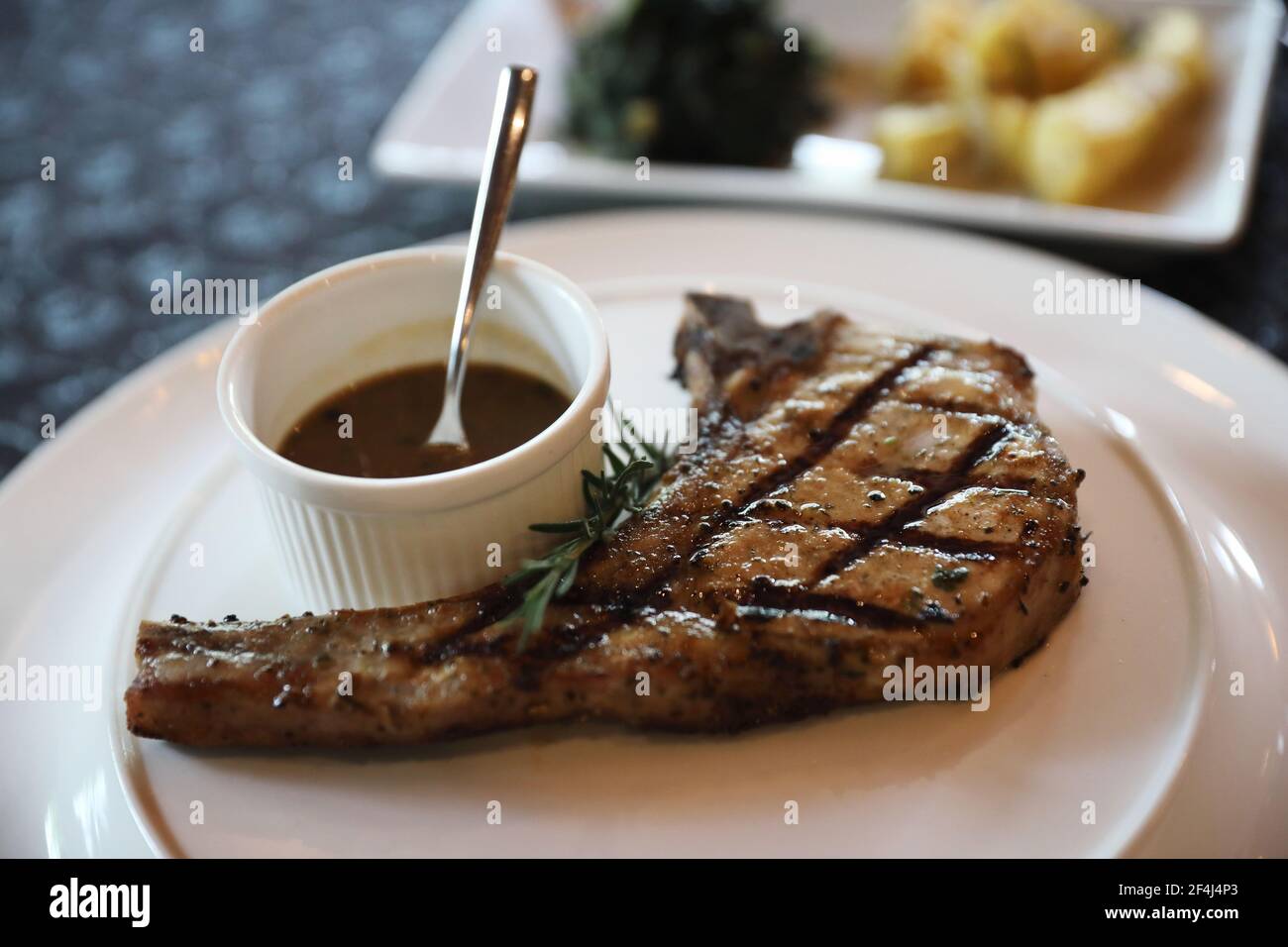 Pork chop steak with Garlic Roasted Potatoes Stock Photo
