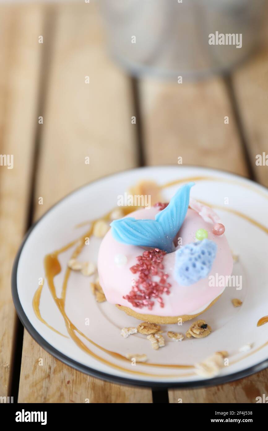 Fancy donut with cute mermaid on top Stock Photo