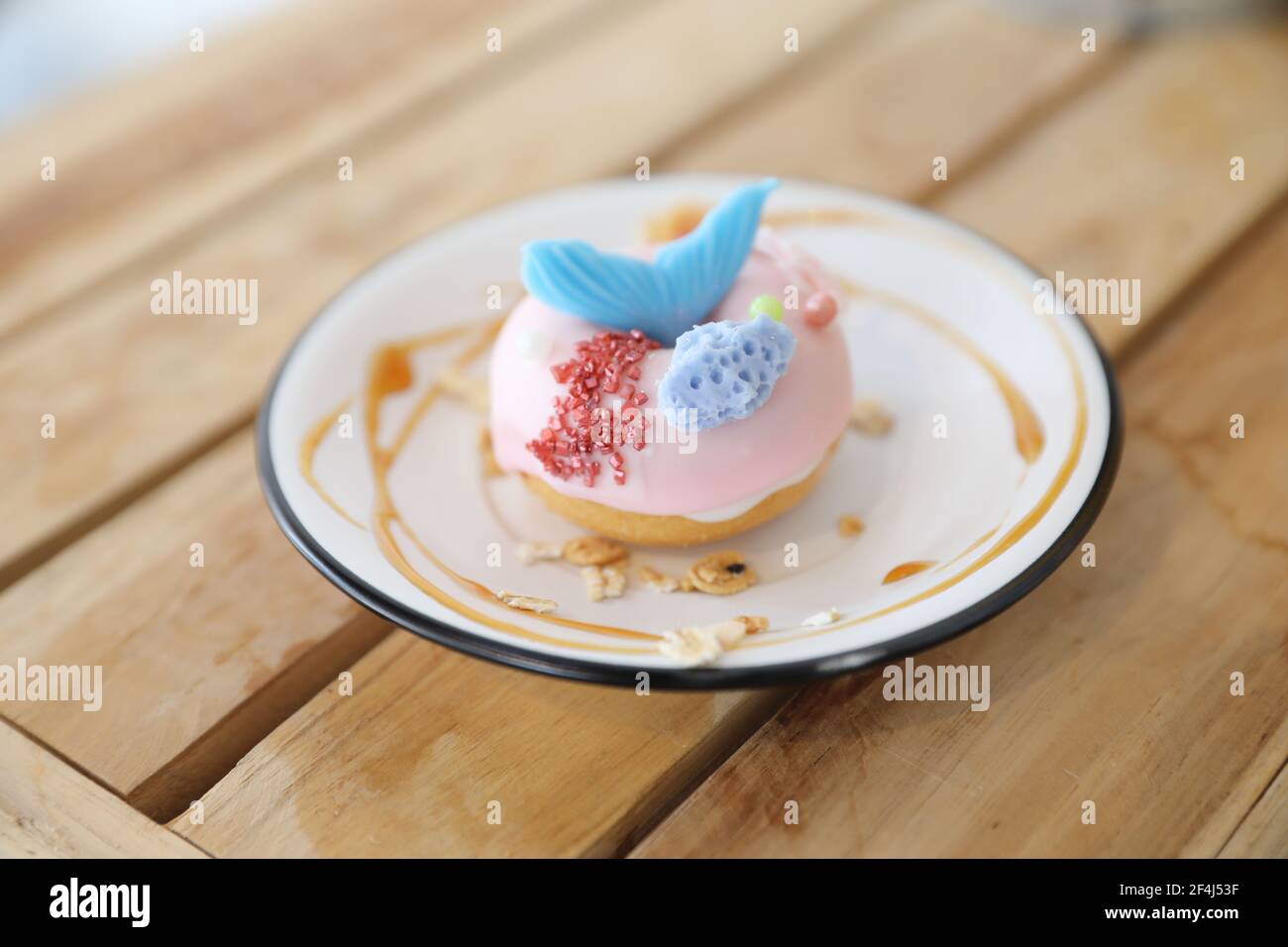 Fancy donut with cute mermaid on top Stock Photo